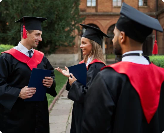 multinational-female-male-graduate-speaking-graduation-robes-university-campus